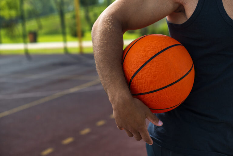 Man holding ball basketball